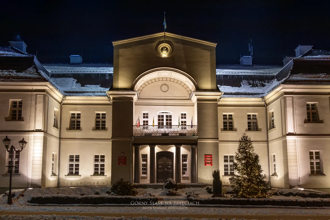 Klasycystyczny pałac w Tworogu – widok od frontu z ryzalitem i balkonem wspartym na żeliwnych kolumnach.